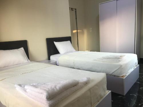 开罗Comfort suite的一间设有两张床铺和毛巾的房间