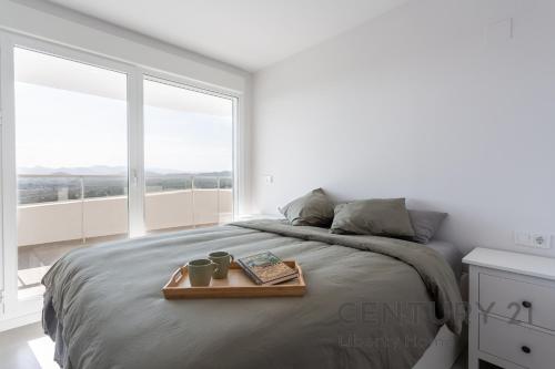 卡耐特蒂贝兰格Apartamento de lujo con 3 habitaciones en Canet d'en Berenguer的一间白色的卧室,配有一张带托盘的床