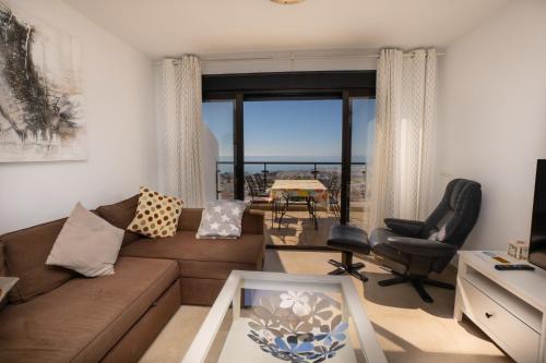 内尔哈Apartamentos & SPA Torres de San Juan的带沙发的客厅,享有海景
