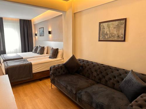 伊斯坦布尔HARRAN HOTEL的客厅配有沙发和1张床