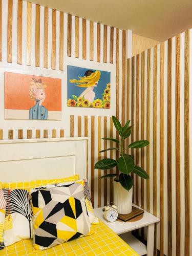 MarilaoBulacan Staycation At Urban Deca Homes Marilao的一间卧室配有一张床和盆栽植物