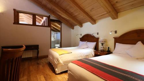 圣克里斯托瓦尔-德拉斯卡萨斯Hotel Casa de Familia de San Cristobal的一间卧室设有两张床和窗户。