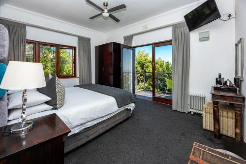 开普敦马顿斯宾馆的一间卧室设有一张床、一台电视和窗户。