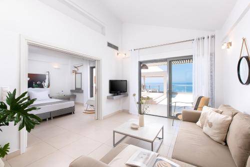 斯卡费迪亚爱奥尼亚马雷代套房度假酒店的客厅配有沙发和1张床