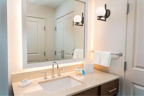 兰乔科尔多瓦Homewood Suites By Hilton Rancho Cordova, Ca的一间带水槽和大镜子的浴室