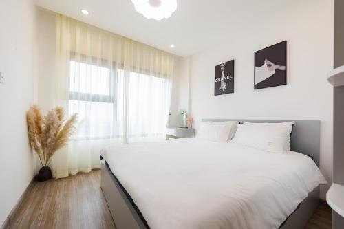 Rimini house Homestay at Vinhome Ocean Park客房内的一张或多张床位