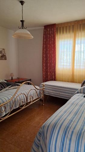 巴切诺La Beccaccia的一间卧室设有两张床和窗户。