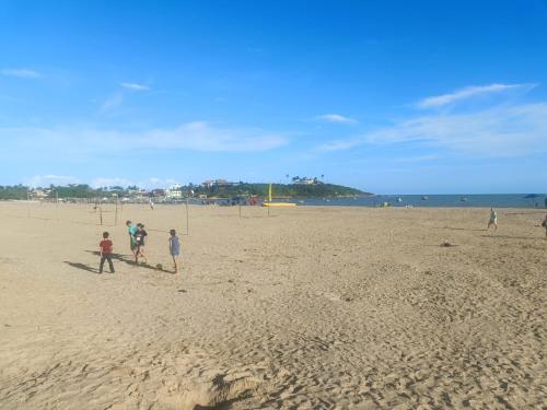 瓜拉派瑞Casa de Temporada Meaipe的一群人在海滩上玩耍