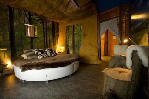 斯塔茨卡纳尔City Hotel Restaurant Stadskanaal的树木间内一间卧室,配有一张床