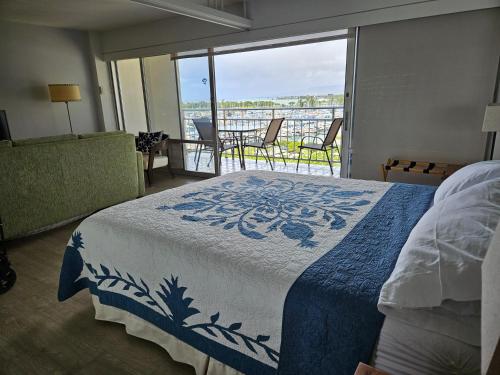 檀香山Ilikai Hotel Condo with Kitchen and Ocean View的一间卧室设有一张床和一个美景阳台