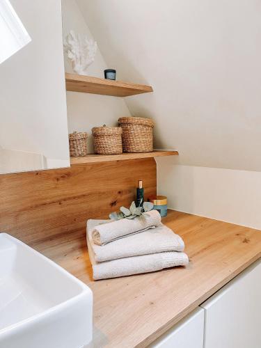 布鲁日Cozy Guesthouse的浴室设有木制柜台上的白色毛巾