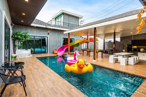 七岩White Cloud & Brown Sand Luxury Pool Villa Cha-Am的一座带充气鸭子的游泳池
