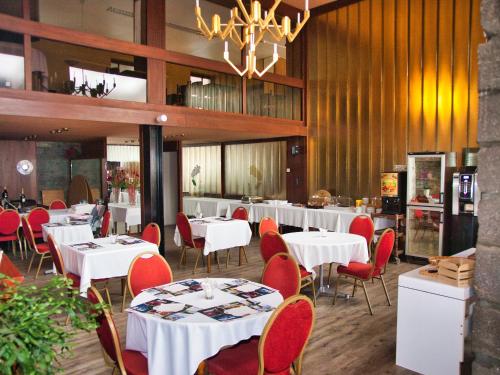 沙泰勒吉永巴黎酒店的用餐室配有白色的桌子和红色的椅子