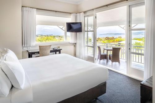 陶波希尔顿陶波湖酒店的酒店客房设有一张床和一个阳台。