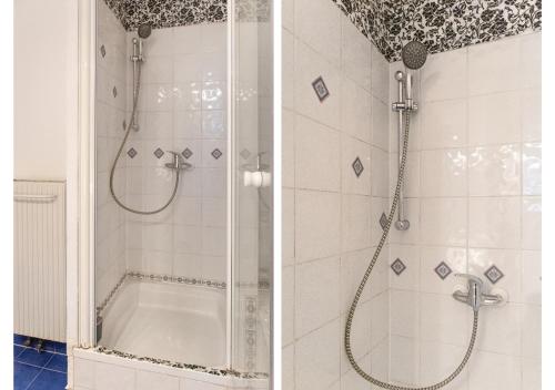 维也纳Deluxe 3BR Apt. Wiener Stadthalle - Suitable for Longstays的浴室设有玻璃门淋浴和浴缸