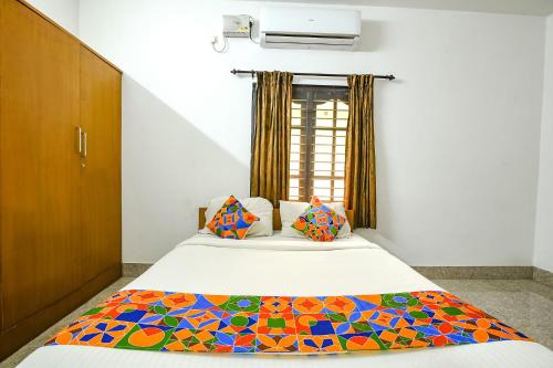 哥印拜陀FabHotel Joy's Residency的一间卧室设有一张床和一个窗口