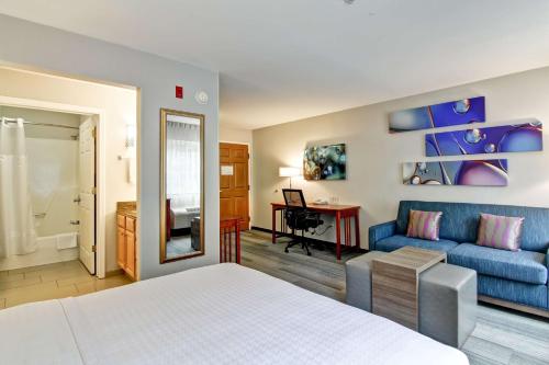 斯特拉特福德斯特拉特福德希尔顿惠庭套房酒店的一间卧室设有一张床和一间客厅。