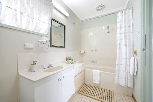沃纳姆堡City Heart Motel Warrnambool的白色的浴室设有水槽和淋浴。