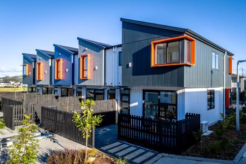 奥克兰Charming Urban Townhouse Getaway的一排带橙色窗户的房屋