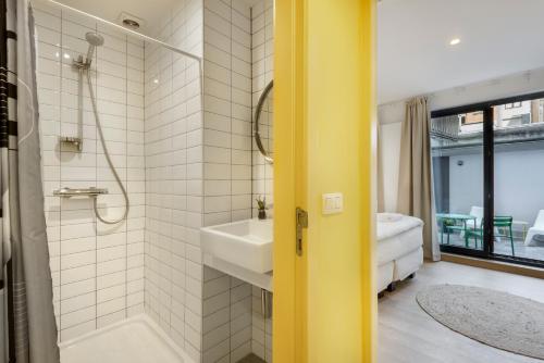 安特卫普R73 Apartments by Domani Hotels的带浴缸、水槽和淋浴的浴室