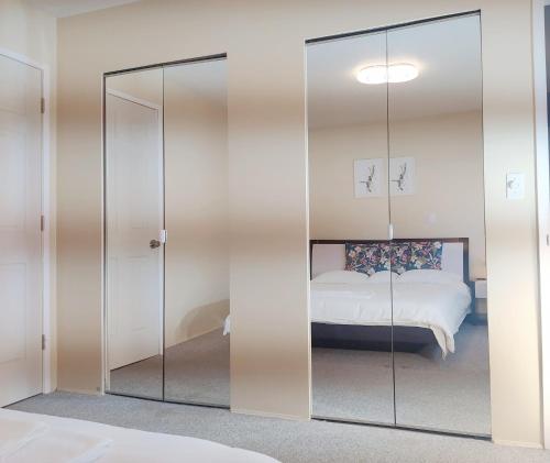 里士满Master room &full bathroom with separate entrance in richmond的带玻璃隔板和床的房间