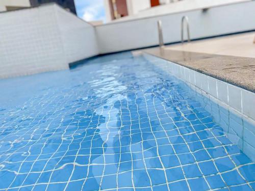 萨尔瓦多Axé home - Apartamento conceito em Salvador的游泳池的顶部铺有蓝色瓷砖