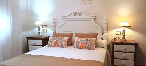 普里埃格·德·科尔多巴Apartamento Puerta Grana Priego.的一间卧室配有一张大床、枕头和两盏灯。