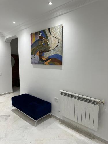 突尼斯Appartement haut standing 170 m2的墙上的画,有长凳的房间