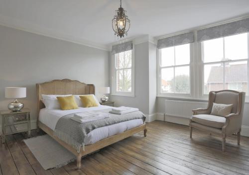 绍斯沃尔德Bay House的一间卧室配有一张床、一把椅子和窗户。