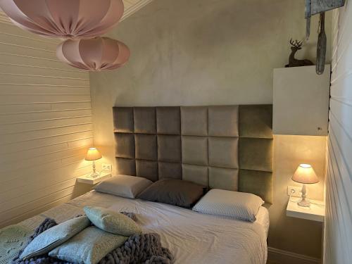 聚滕达尔Chalet Maurice的一间卧室配有一张大床和两盏灯