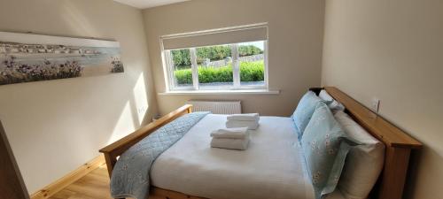 巴林罗布Reed Warbler Cottage的一间卧室设有一张床和一个窗口
