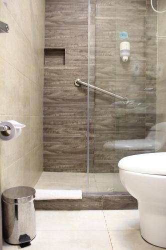波哥大Agora Suites Self-Service Boutique Hotel的浴室设有玻璃淋浴间和卫生间