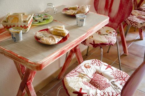 卡斯特尔萨多侬纳斯尼住宿加早餐旅馆的一张木桌,上面放着食物和椅子