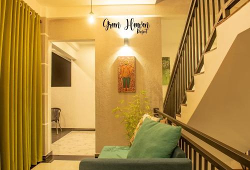 康提Green Heaven Resort Kandy的一个带绿色沙发的楼梯和墙上的标志