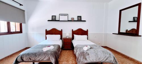 马佐VV Mirador Isla Bonita "by henrypole home"的一间卧室配有两张床和镜子