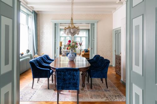 贝茨泰兹瓦赫De Jonge Barones的一间带木桌和蓝色椅子的用餐室