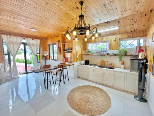 大叻Là Lá La Home的厨房设有木制天花板和桌椅