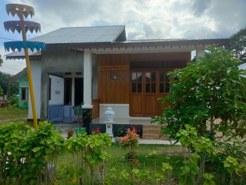 PasarbaruHomestay Melty Aprianti Tanjong Tinggi的前面有花园的小房子