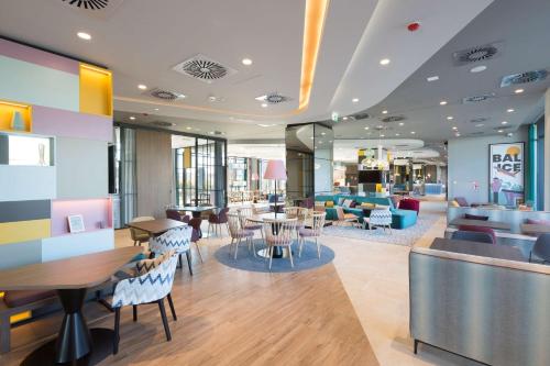 BaliceHampton by Hilton Krakow Airport的大楼内带桌椅的餐厅