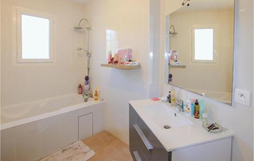 蒙特利马尔3 Bedroom Beautiful Home In Montlimar的一间带水槽、浴缸和镜子的浴室