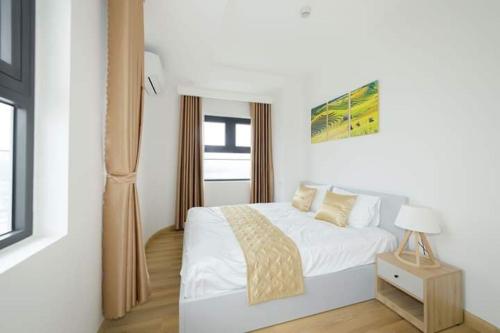 归仁TMS Apartment View Biển Luxury Quy Nhơn的白色的卧室设有床和窗户