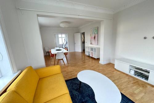 雷克雅未克Beautiful 2 bedroom apartment downtown Reykjavik的客厅配有黄色的沙发和桌子