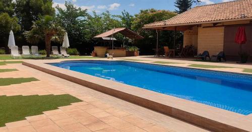 马德里德霍斯Finca El Pilar的一座房子旁的院子内的游泳池