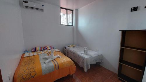 巴克里索莫雷诺港CASA DE NOELIA的小房间设有两张床和窗户