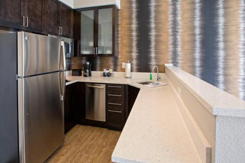 路易斯威尔Residence Inn by Marriott Louisville East/Oxmoor的厨房配有不锈钢冰箱和木制橱柜