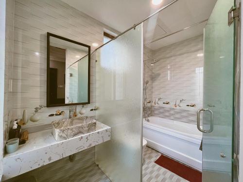 顺化HueNam Residence的带淋浴、盥洗盆和镜子的浴室