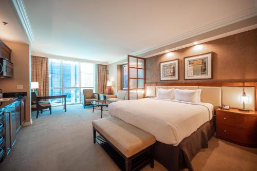 拉斯维加斯NO RESORT FEES-MGM StripView Adjoining Suites F1 View的酒店客房设有一张大床和一间客厅。