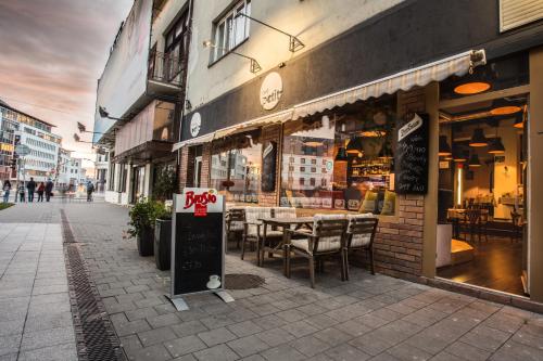 布拉迪斯拉发Downtown Bratislava B&B的街道上的餐厅,前面有标志