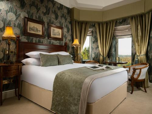 多基费兹帕特里克城堡酒店的一间卧室配有一张床、一张书桌和一个窗户。