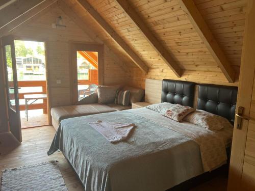 乌尔齐尼Cheerful cabin in Ada bojana的一间卧室配有一张大床和一张沙发